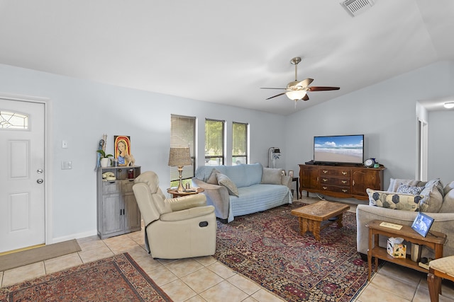 living room with ceiling fan, light tile patterned floors, and lofted ceiling