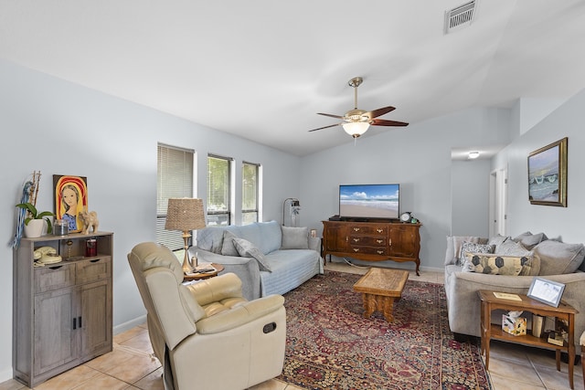 tiled living room with ceiling fan and vaulted ceiling