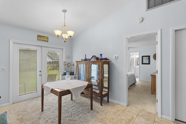 carpeted dining area featuring french doors, an inviting chandelier, and lofted ceiling