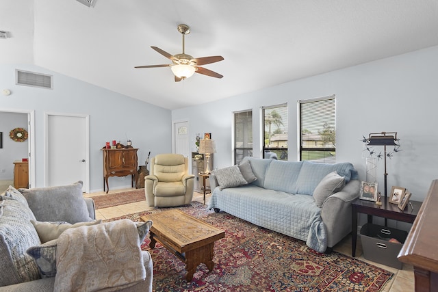 living room with vaulted ceiling, ceiling fan, and light tile patterned floors