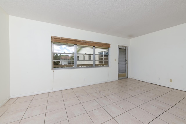 spare room with a textured ceiling