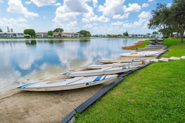 dock area featuring a water view and a lawn