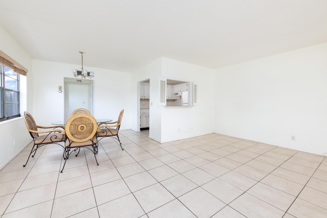 unfurnished dining area featuring an inviting chandelier