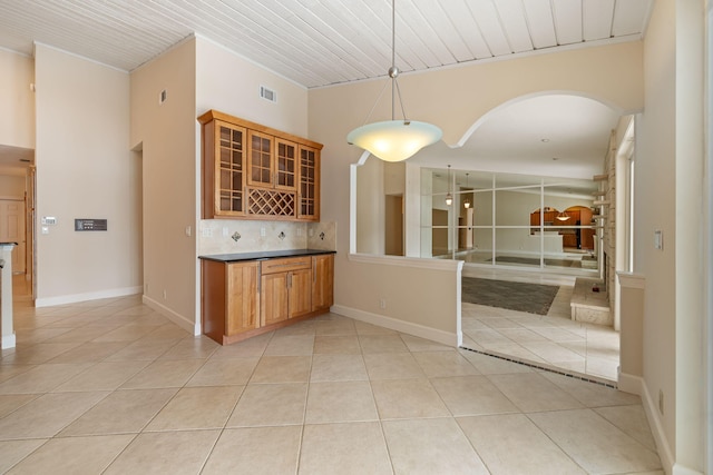 kitchen featuring pendant lighting, light tile patterned floors, and backsplash