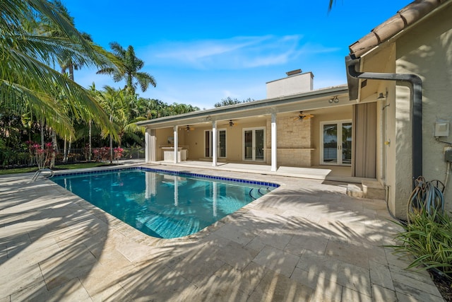 view of swimming pool with ceiling fan and a patio area