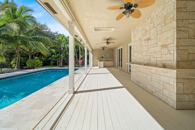 view of pool with area for grilling and ceiling fan