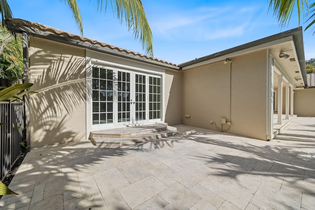 rear view of house featuring a patio and french doors