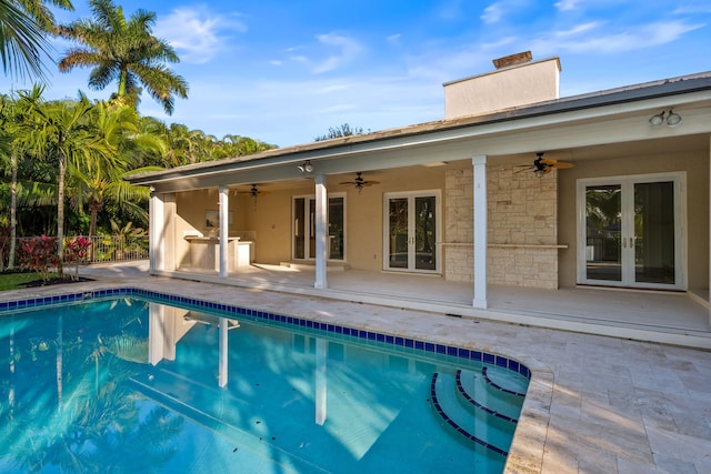 view of pool with a patio, ceiling fan, and french doors