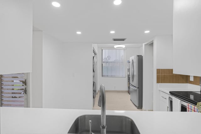 kitchen with white cabinetry, appliances with stainless steel finishes, and sink