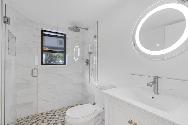 bathroom featuring a shower with door, vanity, and toilet