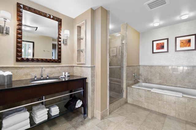 bathroom featuring separate shower and tub, tile patterned floors, and vanity