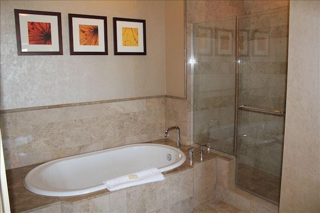 bathroom with separate shower and tub