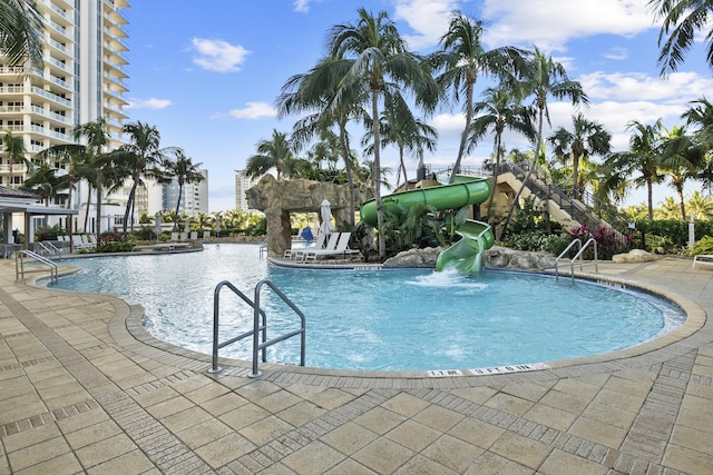 view of pool with a patio area and a water slide