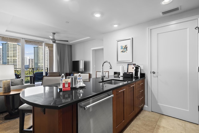 kitchen with a kitchen bar, sink, kitchen peninsula, ceiling fan, and stainless steel dishwasher