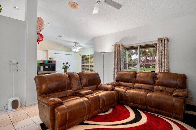 tiled living room featuring lofted ceiling and ceiling fan