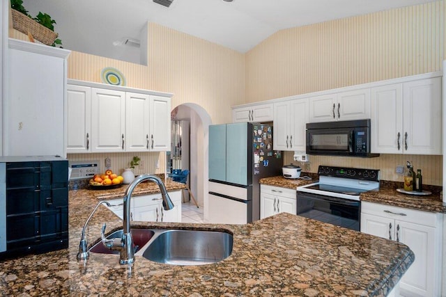 kitchen with white cabinetry, electric range oven, sink, and stainless steel fridge