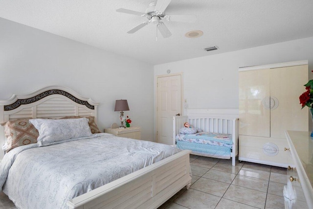 tiled bedroom featuring ceiling fan