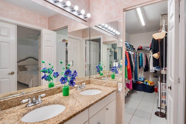 bathroom featuring tile patterned flooring and vanity