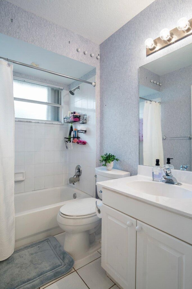 full bathroom featuring toilet, a textured ceiling, vanity, shower / bath combo with shower curtain, and tile patterned flooring