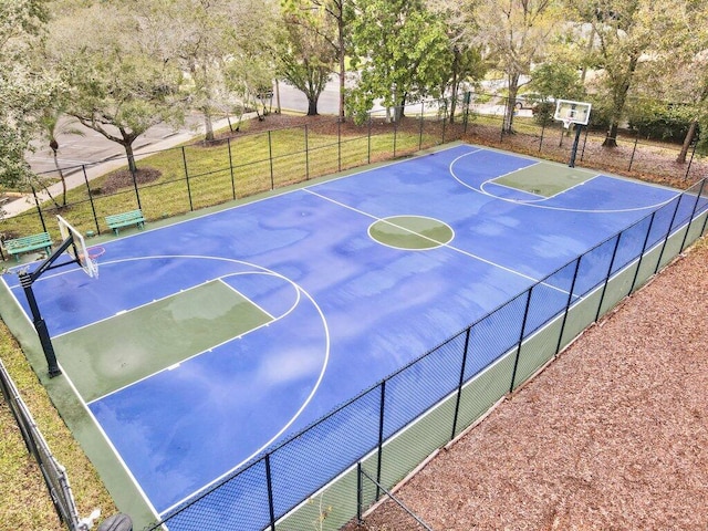 view of sport court with a yard