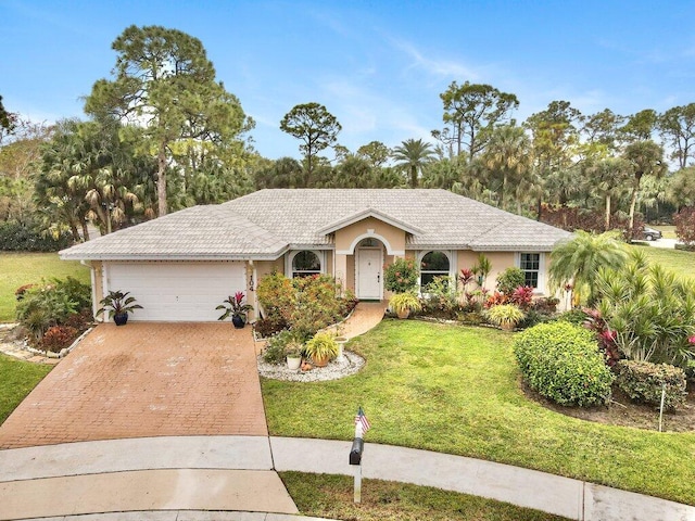 ranch-style house with a garage and a front yard