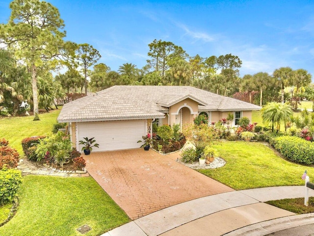 single story home featuring a garage and a front lawn