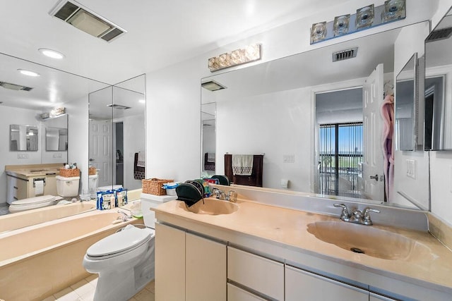 bathroom with vanity, a bathing tub, toilet, and tile patterned flooring