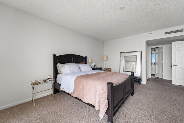 carpeted bedroom featuring a textured ceiling