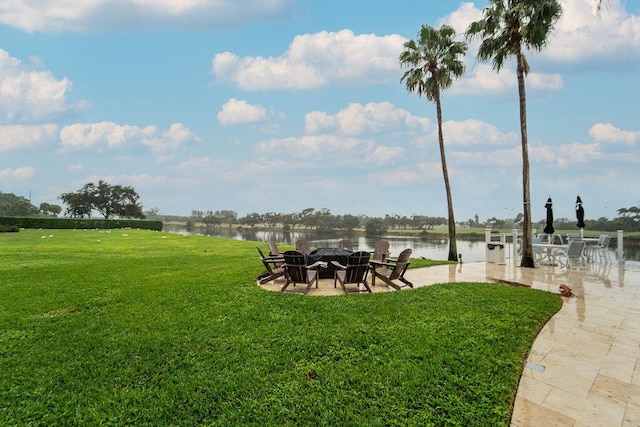 view of yard with a patio area and a water view