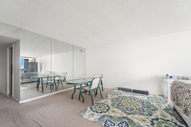 carpeted bedroom featuring a textured ceiling