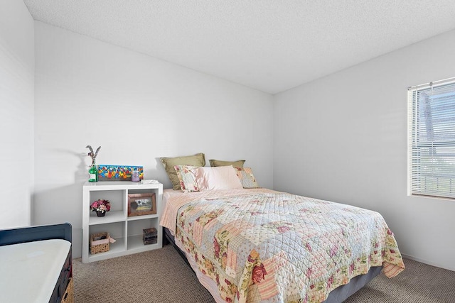 carpeted bedroom featuring a textured ceiling