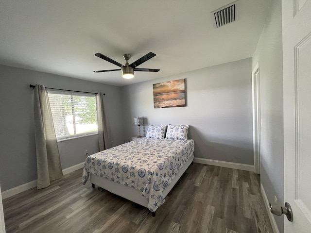 bedroom with ceiling fan and dark hardwood / wood-style floors