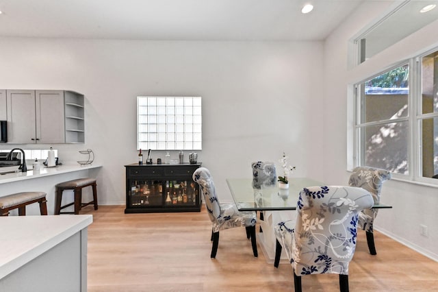 dining space with sink and light wood-type flooring