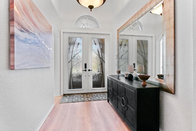 entrance foyer featuring hardwood / wood-style floors and french doors