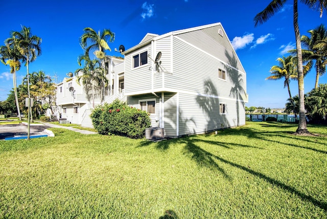 rear view of property featuring a lawn