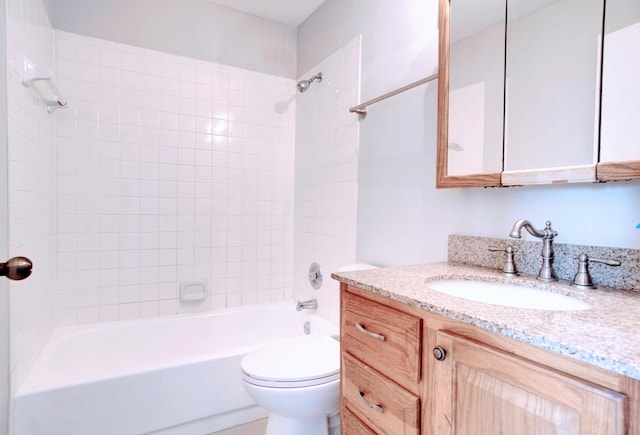 full bathroom featuring toilet, vanity, and tiled shower / bath