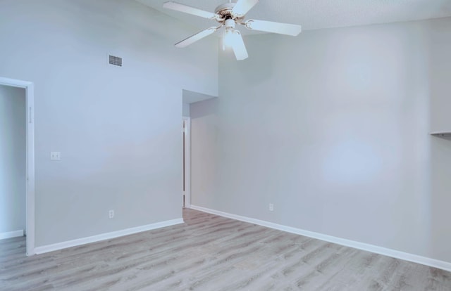 unfurnished room with a textured ceiling, light hardwood / wood-style flooring, high vaulted ceiling, and ceiling fan