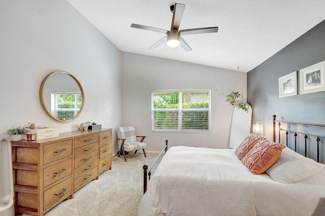 carpeted bedroom featuring lofted ceiling and ceiling fan