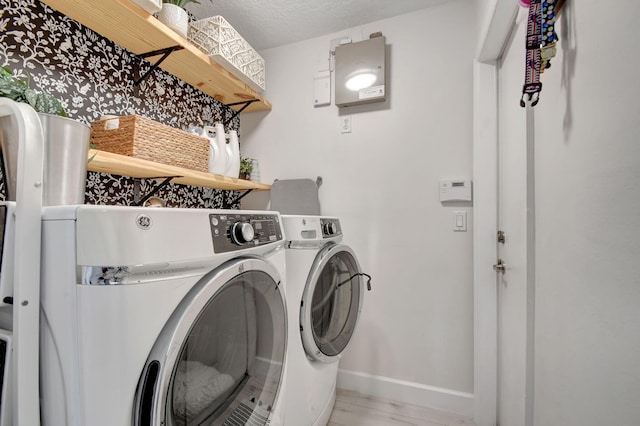 laundry room featuring washer and dryer and a textured ceiling