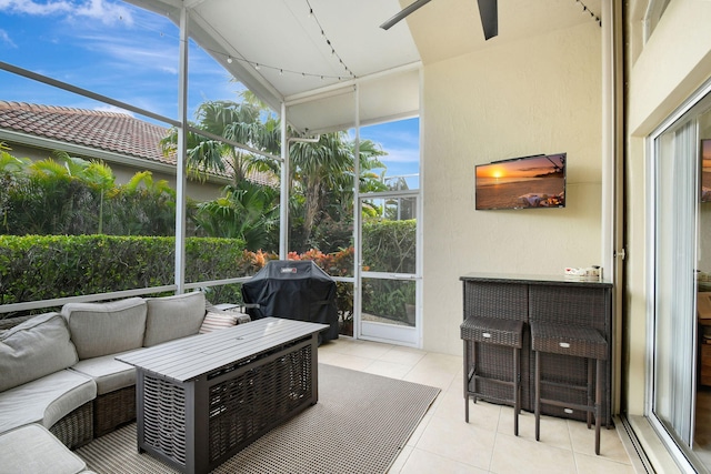 sunroom featuring ceiling fan