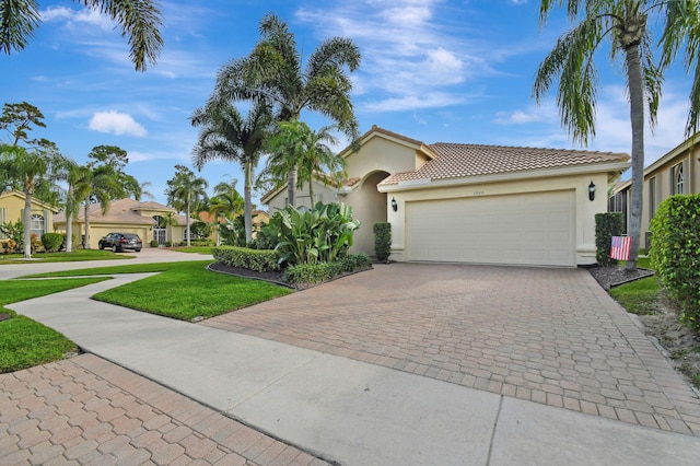 mediterranean / spanish-style house with a garage and a front yard