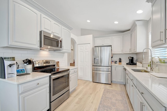 kitchen with white cabinetry, stainless steel appliances, and sink