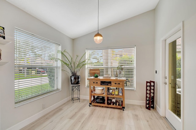 sitting room featuring plenty of natural light and vaulted ceiling