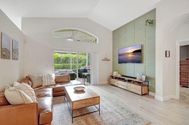 living room featuring light hardwood / wood-style flooring and high vaulted ceiling