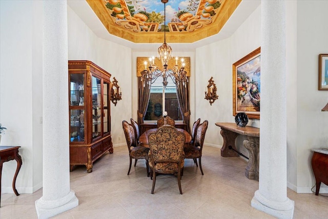 tiled dining area with ornate columns, a raised ceiling, and a notable chandelier