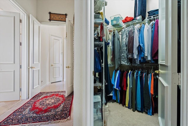 walk in closet with light tile patterned floors