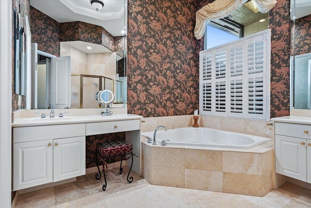 bathroom with vanity and shower with separate bathtub