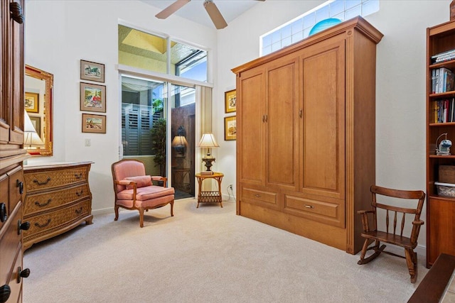 sitting room featuring light carpet and ceiling fan