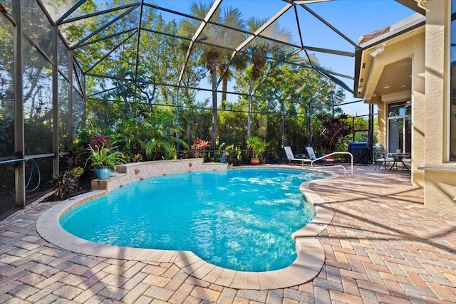 view of pool featuring a patio area and glass enclosure