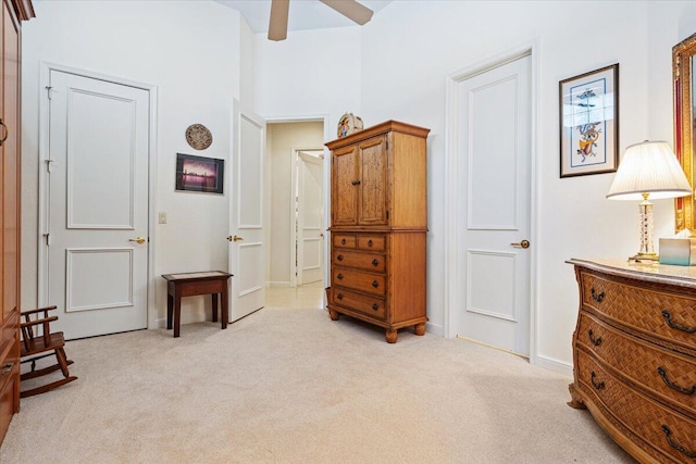 living area with light colored carpet and ceiling fan